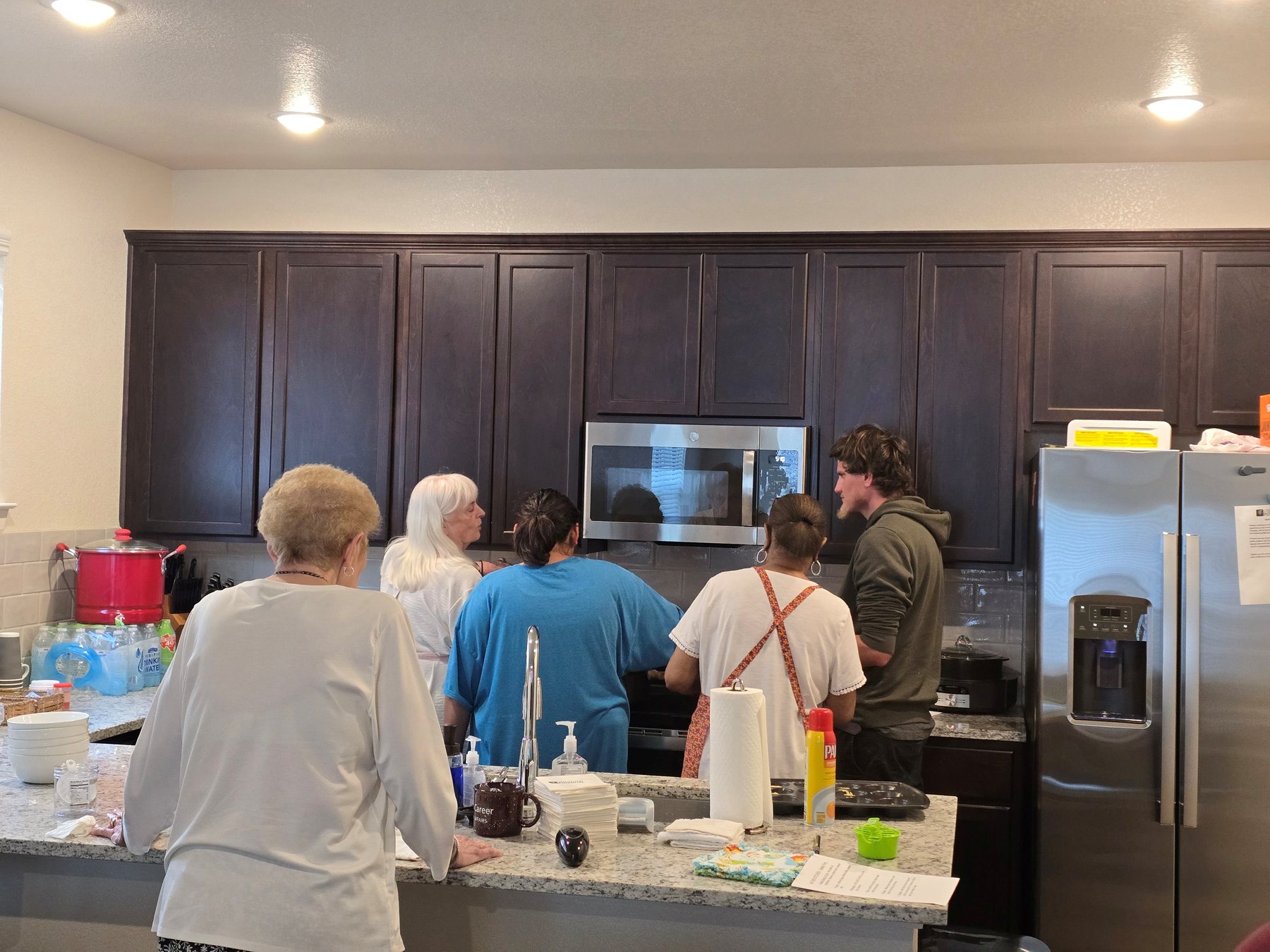 People practicing cooking and kitchen skills together